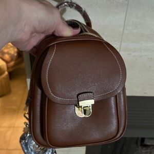 Small, convenient-backpack-crossbody bag.  New with tags.